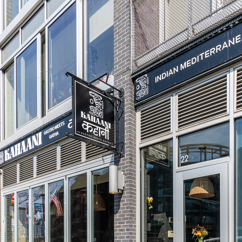 Exterior view of Kahaani restaurant, featuring a black sign with white text and a tiger logo.